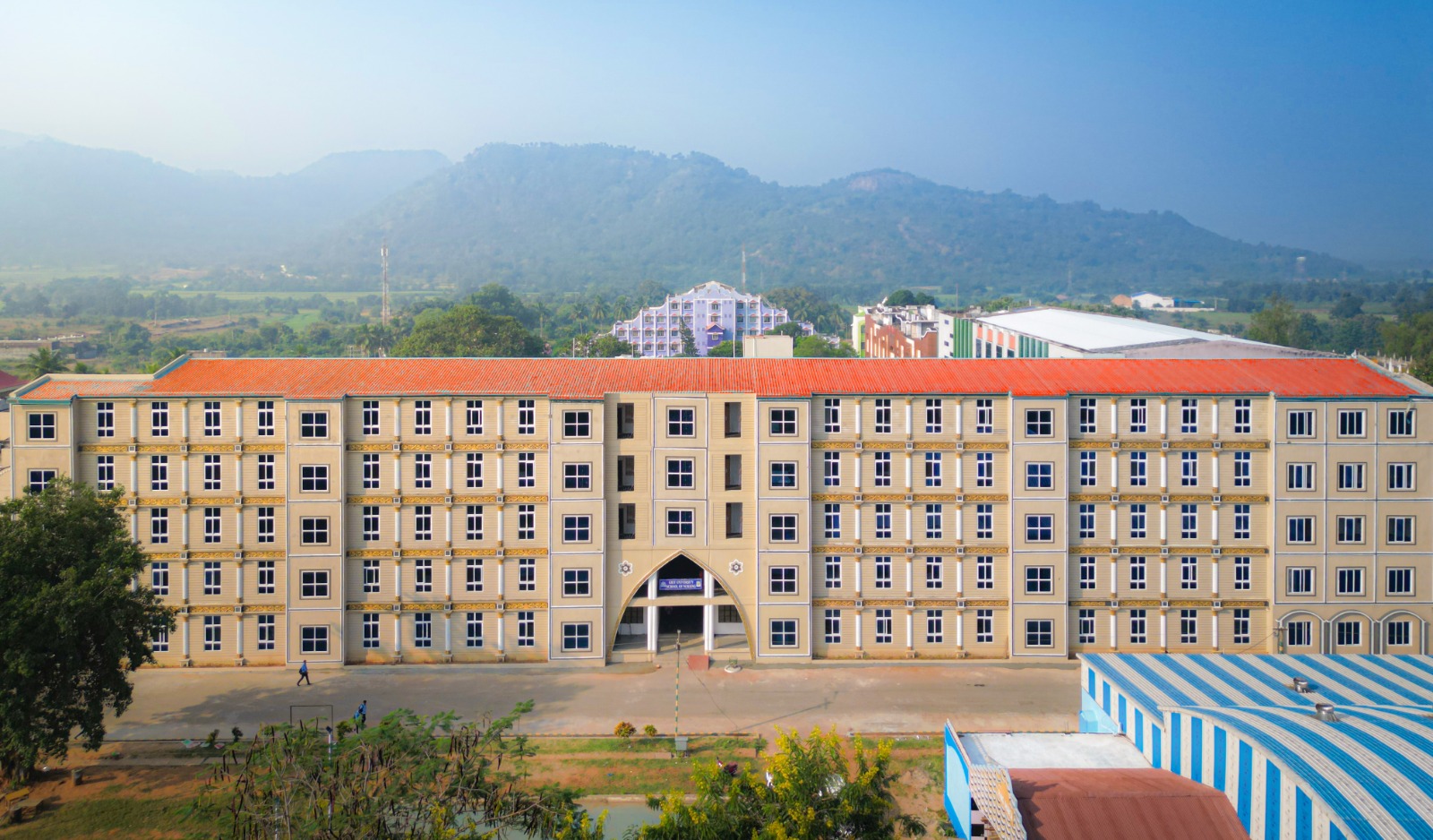 Aerial view of an academic building with hills in the background