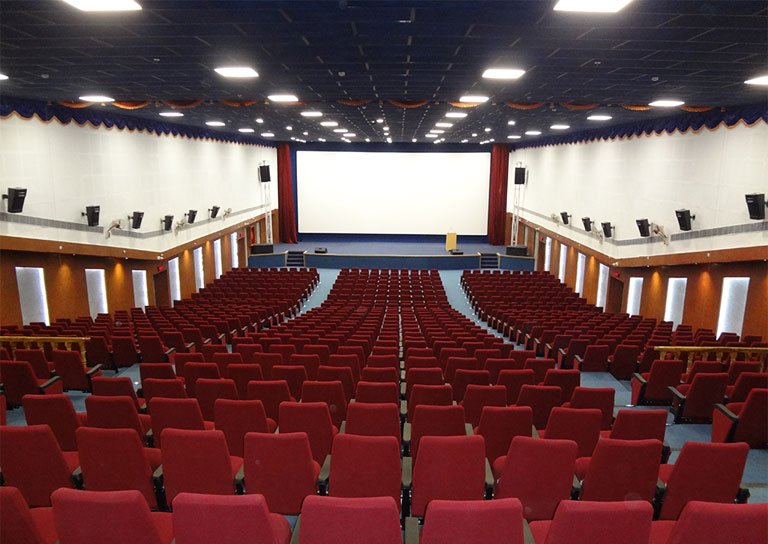 Mega auditorium with stage and screen, red seating