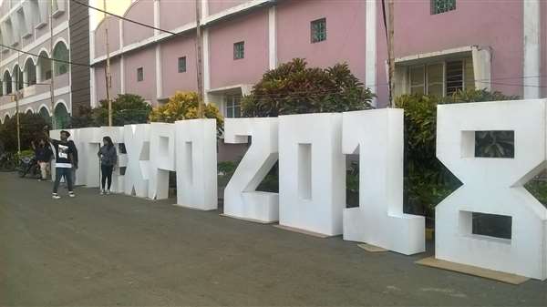 Large EXPO 2018 lettering display outside a campus building
