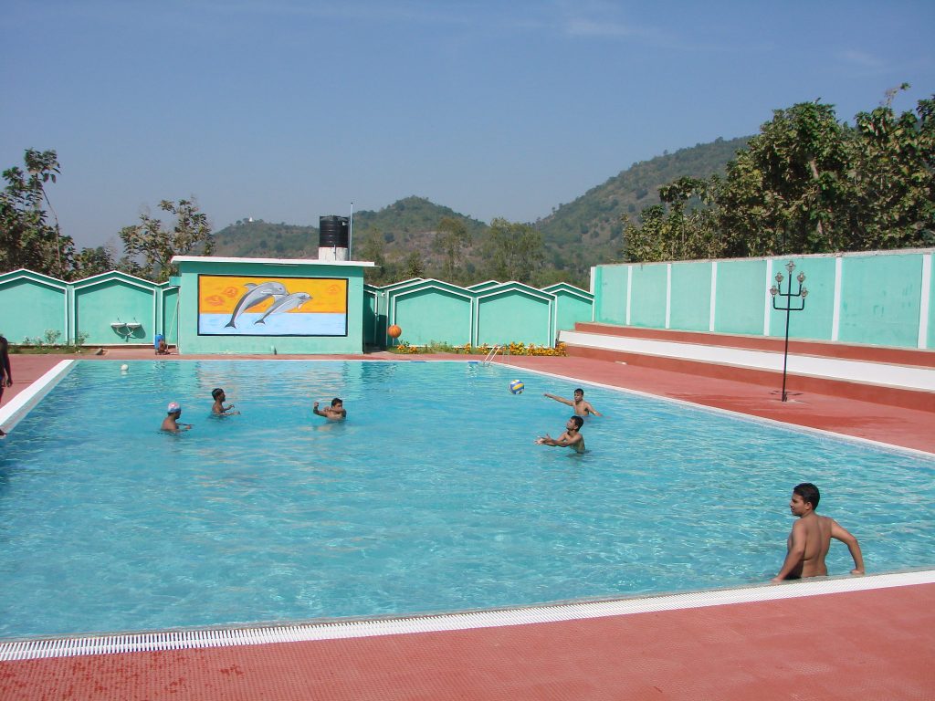 Students playing in the campus swimming pool
